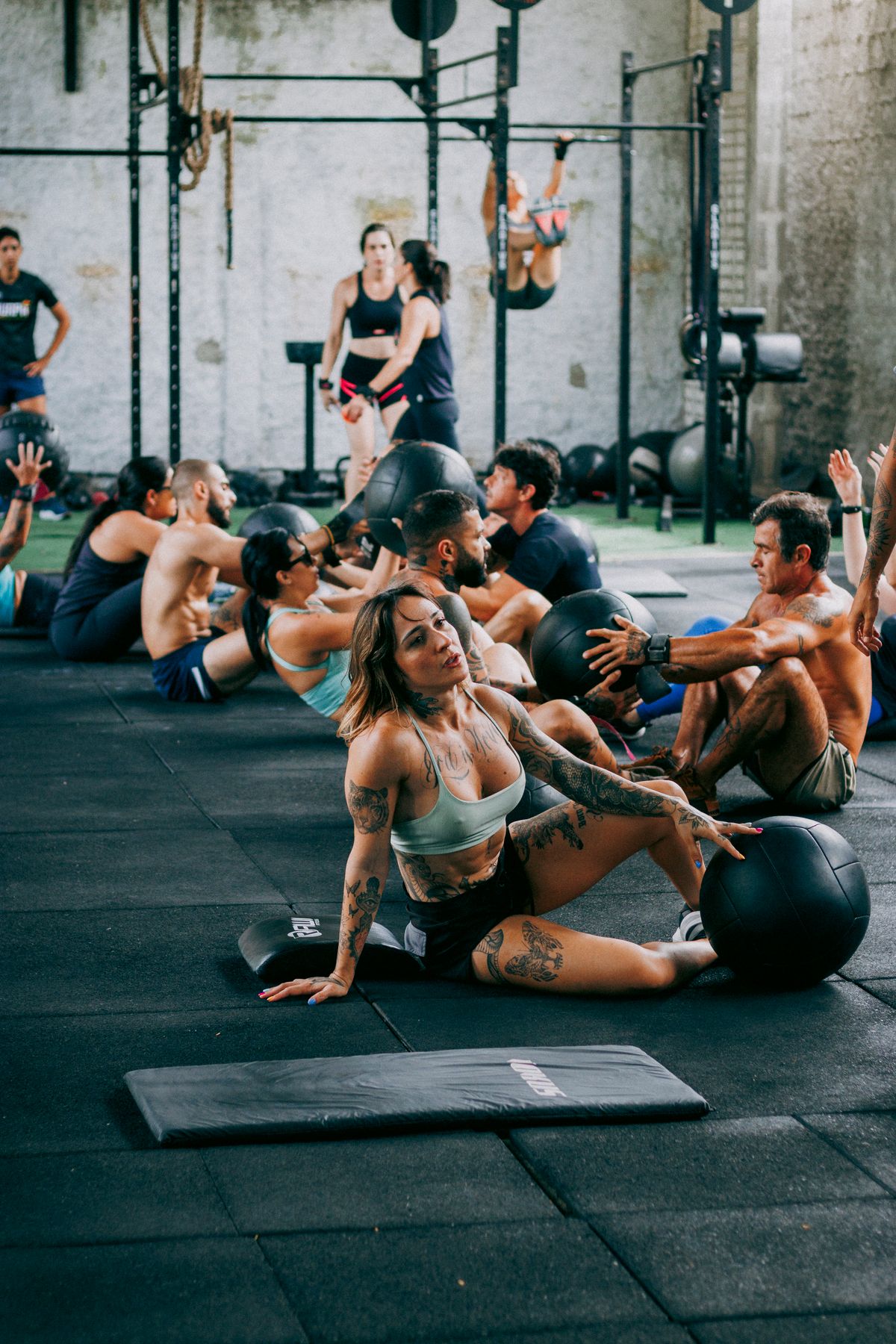 A group fitness class training with medicine balls in a gym